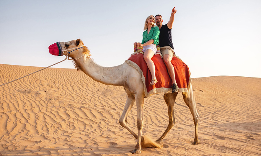 Guests enjoying camel ride during morning safari